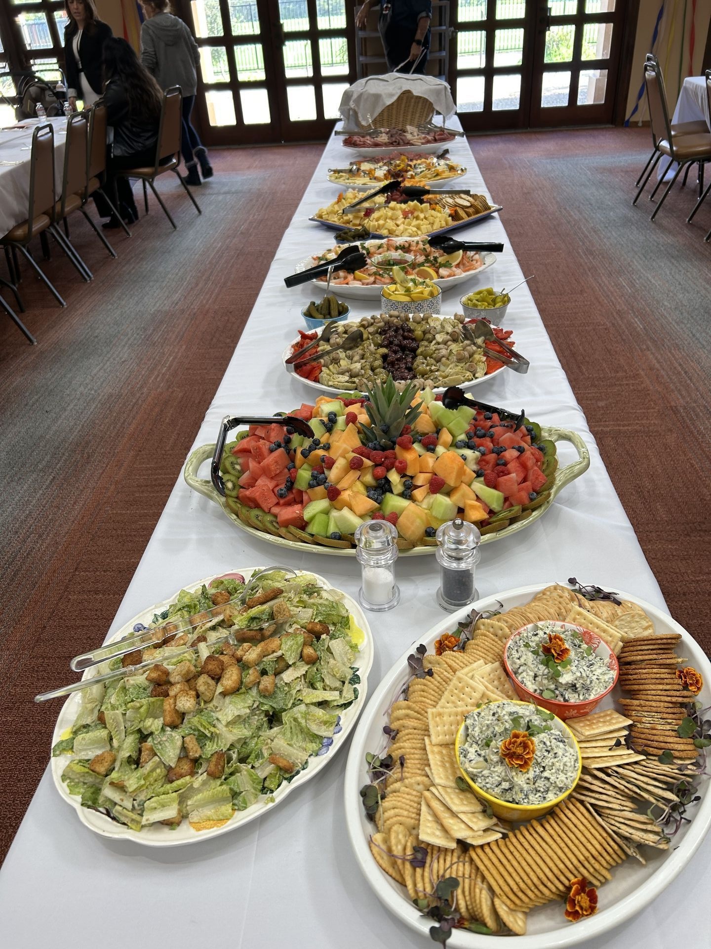 Full event catering setup with multiple dishes and beautiful table presentation