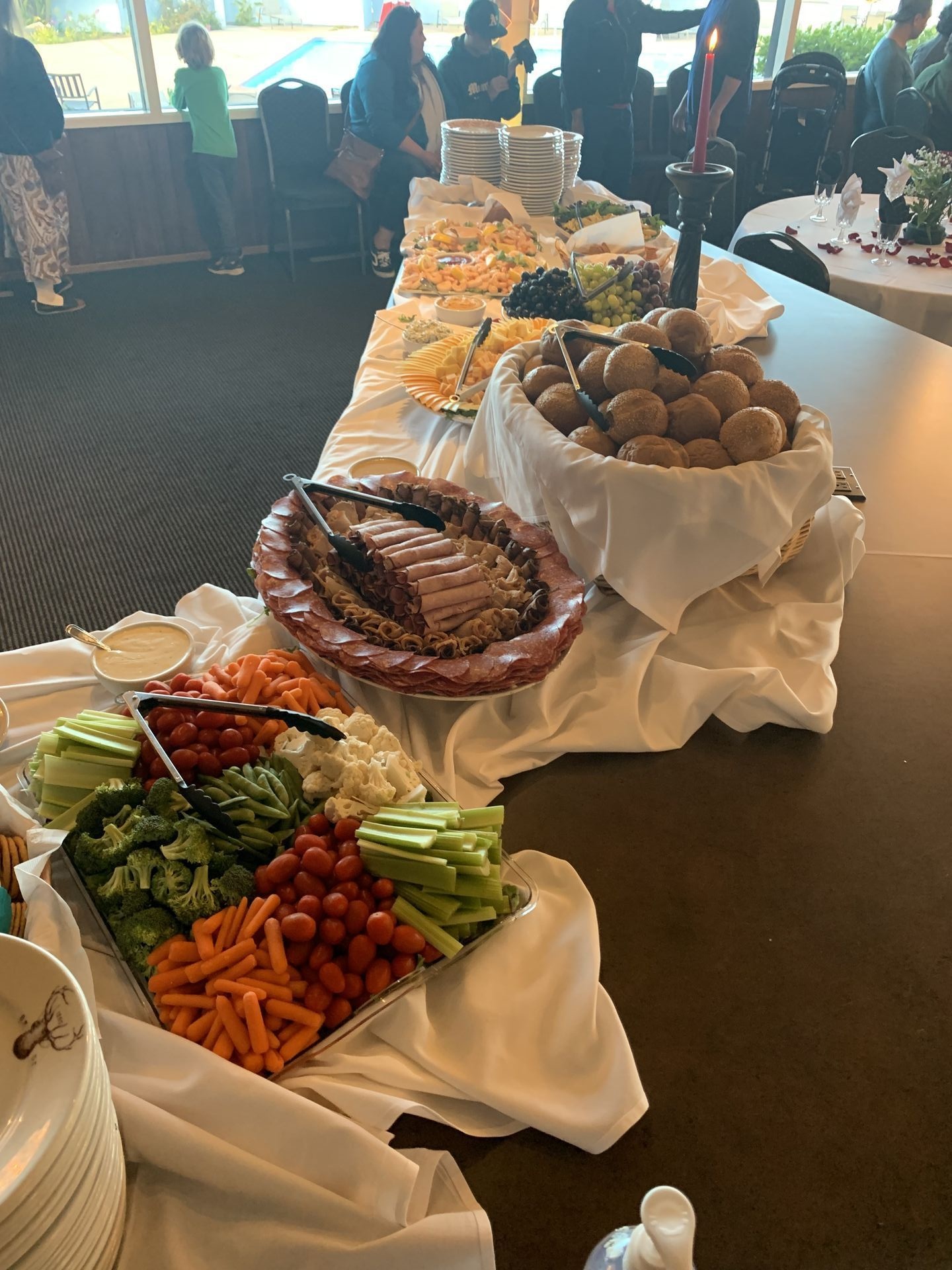 Elegant buffet table with trays of salads, meats, and appetizers
