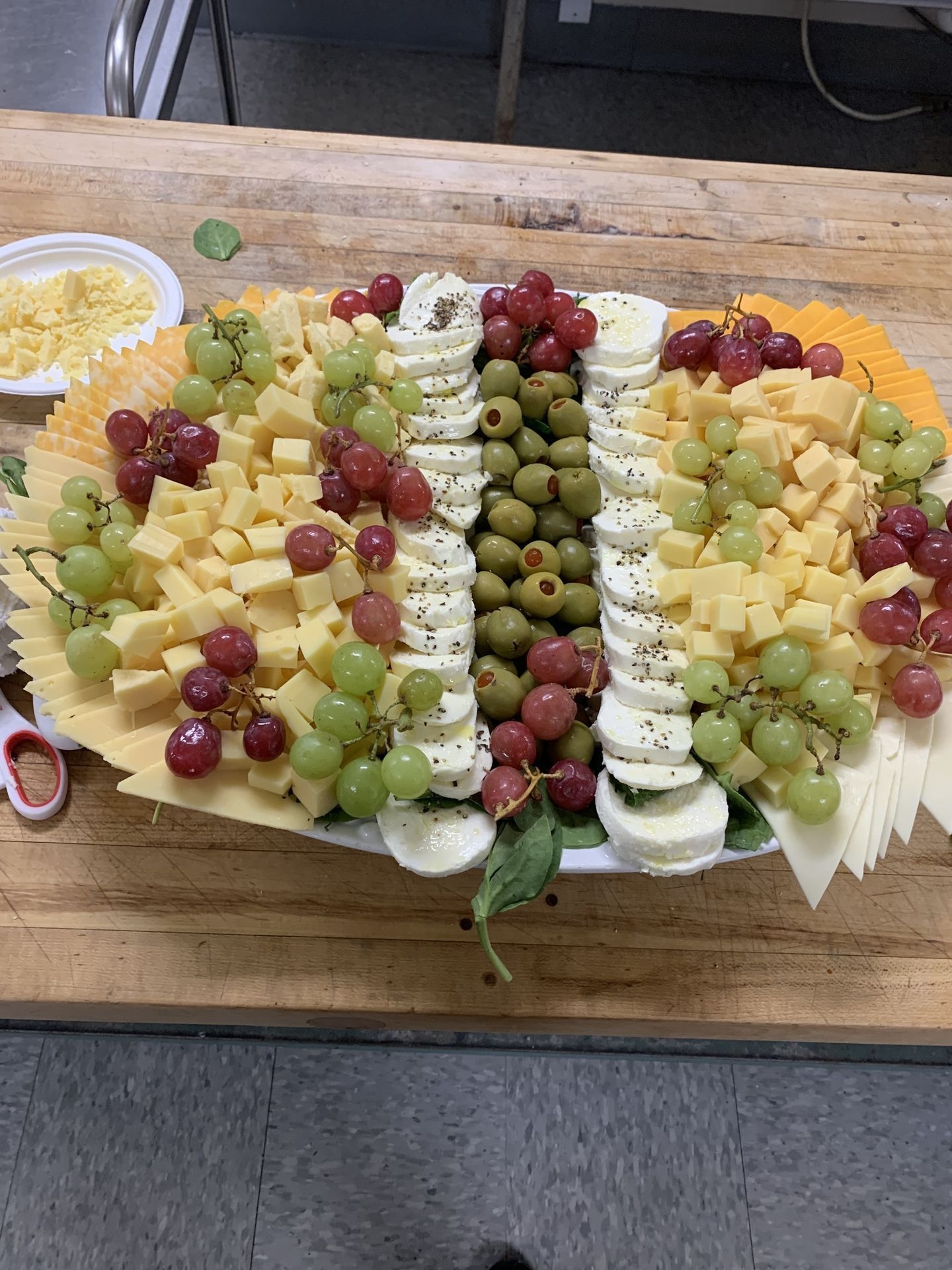 Mixed cheese and fruit tray with grapes, cheese, and crackers